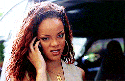 Rihanna making a confused and irritated facial expression while talking over a phone